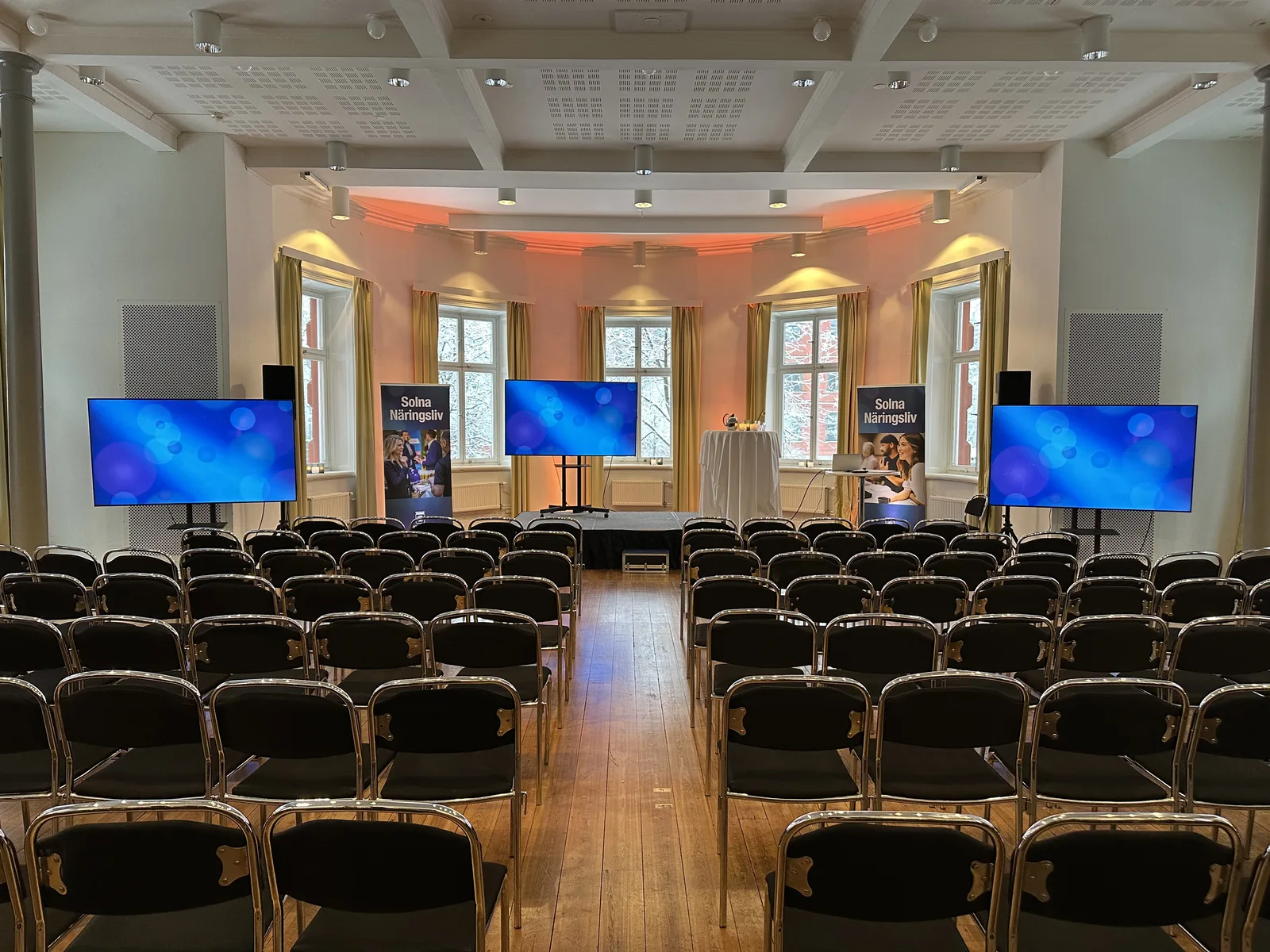 Konferens med orange uplight — Solna Näringsliv